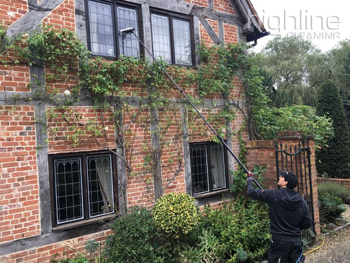 Highline Cleaning window cleaner at work on a house