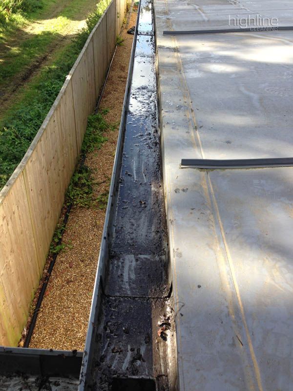 Gutter vacuum pole reaching up to a roof line