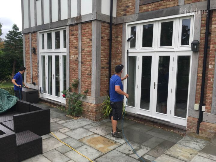 Highline Cleaning window cleaner using a water-fed pole