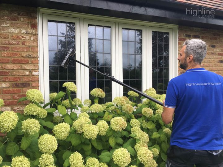 Highline Cleaning window cleaner at work on a customer home