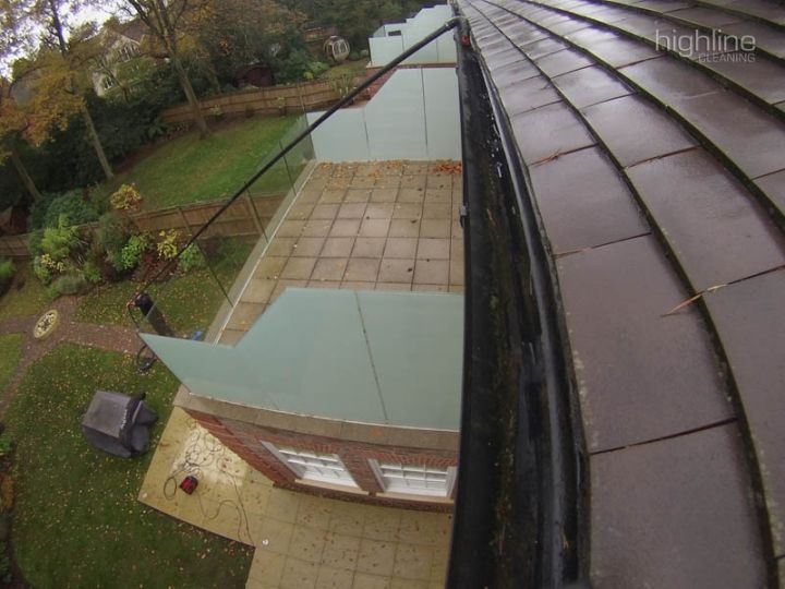 A gutter full of leaves and moss before cleaning
